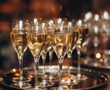Elegant champagne glasses on a silver tray, evoking a sense of celebration and luxury at the hotel bar.