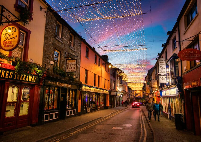 Charming street with vibrant shops, cosy lights, and lively evening vibe, perfect for exploring local culture and dining.
