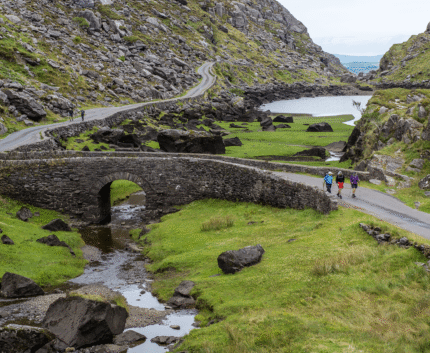 Picturesque stone bridge and lush valleys near scenic hotel in tranquil countryside, perfect for outdoor adventures.