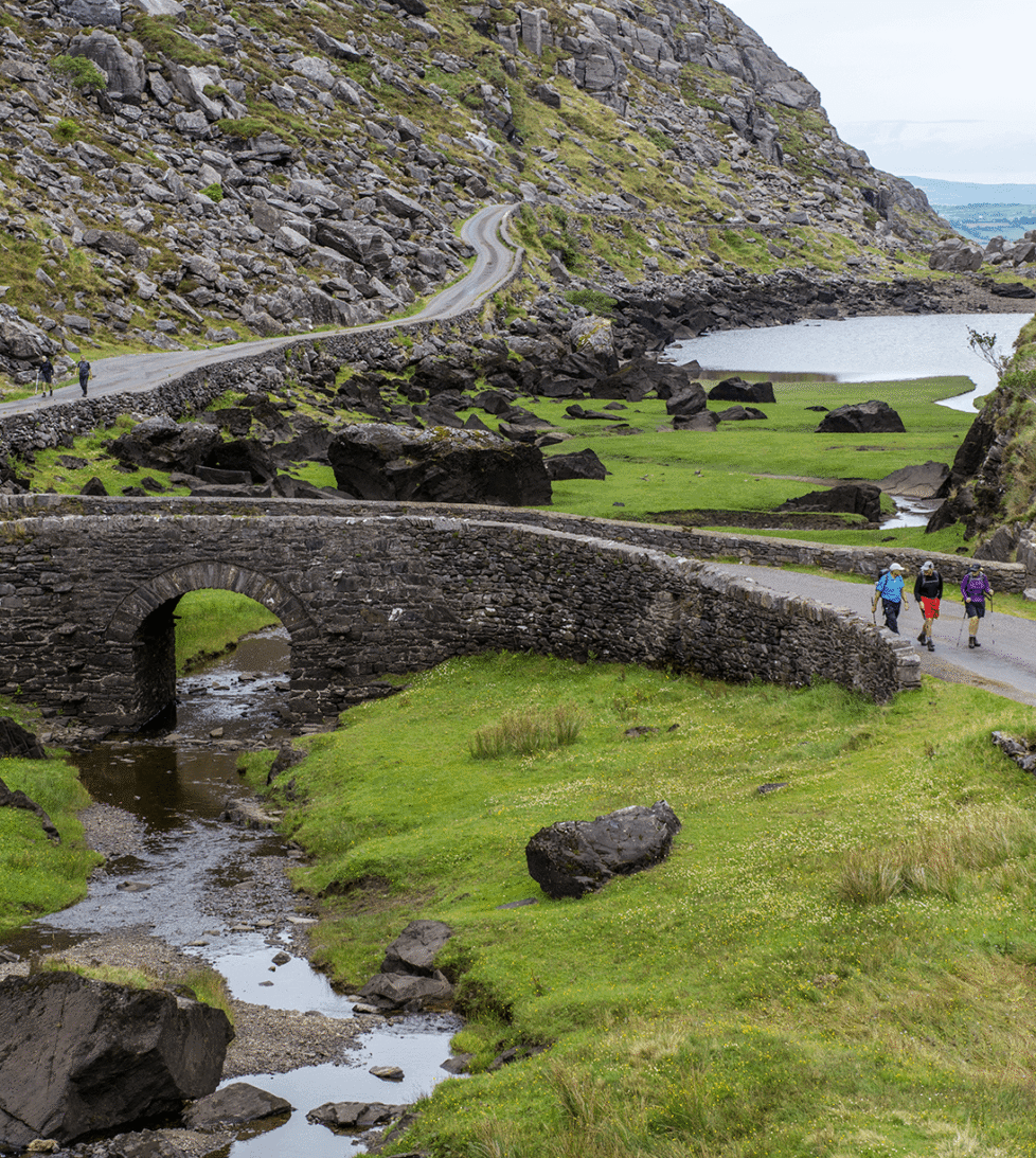 Picturesque stone bridge and lush valleys near scenic hotel in tranquil countryside, perfect for outdoor adventures.